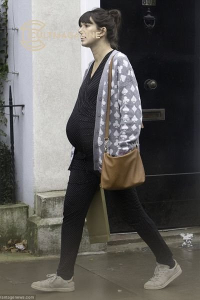 Showed off her blossoming baby bump in a tight polka dot jumpsuit, as she enjoyed a low-key shopping trip in North London